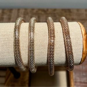 Gold colored roll on bracelets set of 4.